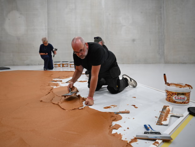 Completely nuts: Dutch gallery covers floor in peanut butter to honour late artist.